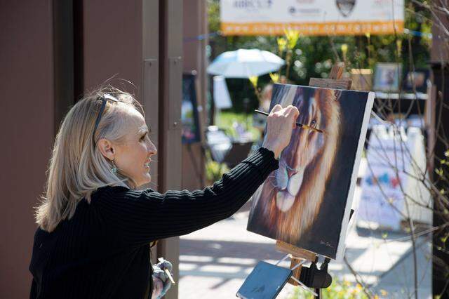 Artist painting live at a previous Keller Art festival